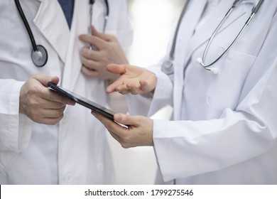 Doctors reviewing medical records with digital tablet
 - Powered by Shutterstock