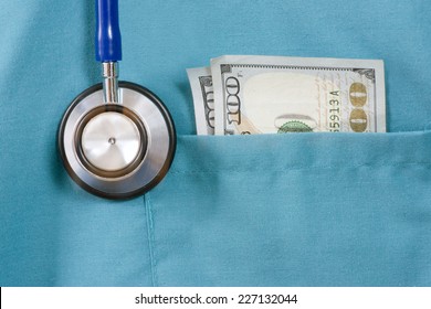 Doctor's scrub pocket with stethoscope and US one hundred dollar bills.