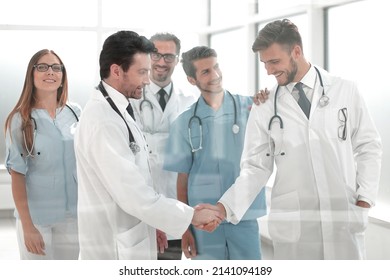 doctors shaking hands in hospital corridor - Powered by Shutterstock