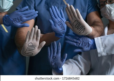 Doctors Showing Signs On Their Palms STOP, HELP, VIRUS, COVID. Abstract Pattern From Hands Of Medical Workers Wearing Disposable Gloves With Inscriptions Regarding The Coronavirus Pandemic.