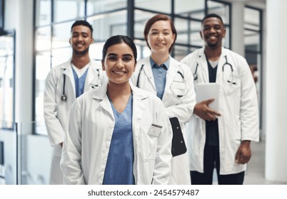 Doctors, smile and portrait in hospital standing together for healthcare, wellness and solidarity. Clinic, surgeons or physicians in group for medical advice, teamwork or collaboration in medicine - Powered by Shutterstock