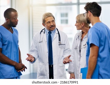 Doctors Talk, Brainstorm And Plan Together To Collaborate And Discuss Medical Procedures In A Hospital. Health Professional Colleagues Consult And Working Together In A Meeting While Sharing Ideas