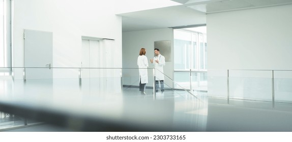 Doctors talking in hospital corridor - Powered by Shutterstock