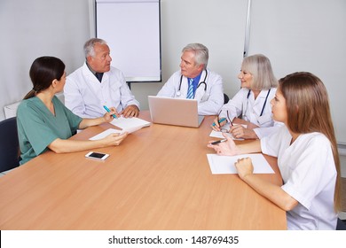 Doctors Talking In A Team Training Seminar