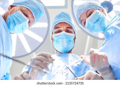 Doctors Team In Surgery During Operation Over Patient During Surgical Procedure