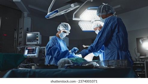 Doctors, team and surgery in theater with medical support for healthcare, safety and operation room at hospital. Surgeon, medicine and teamwork or collaboration with tools for cardiology or emergency - Powered by Shutterstock