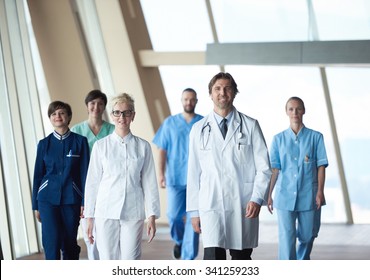 Doctors Team Walking In Modern Hospital Corridor Indoors, Poeople Group