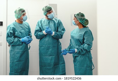 Doctors wearing ppe equipment face surgical mask and visor fighting against corona virus outbreak - Health care and medical workers concept  - Shutterstock ID 1819522436