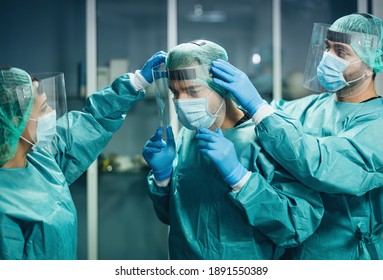 Doctors Wearing Ppe Equipment Face Surgical Mask And Visor Fighting Against Corona Virus Outbreak - Health Care And Medical Workers Concept