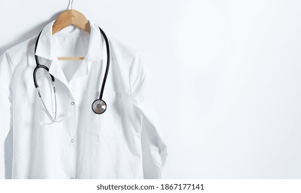 Doctor's white coat with stethoscope on hanger over white background with copy space. Healthcare and medical concept. - Powered by Shutterstock