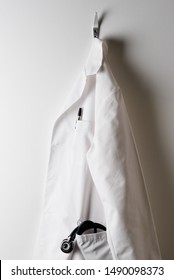 A Doctors White Lab Coat And Hanging On A Hook With Stethoscope In Pocket.