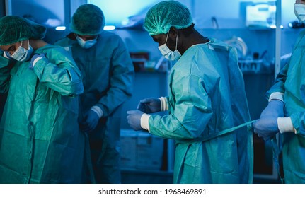 Doctors at work inside hospital during coronavirus outbreak - Medical worker on Covid-19 crisis wearing face protective mask - Focus on black guy head