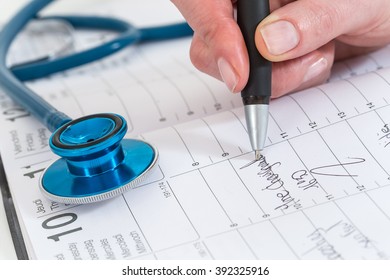   Doctors Writing Appointment  On A Calendar For A Patient  