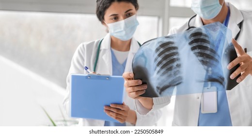 Doctors with x-ray image of lungs in clinic