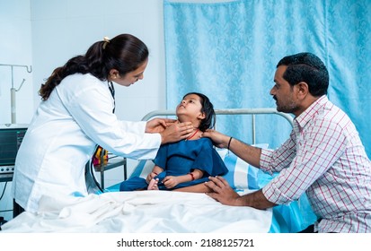 Doctror Examining Throat Infection Of Girl Child At Hospital While With Father - Concept Of Thyroid Problem, Medicare And Inflammation.