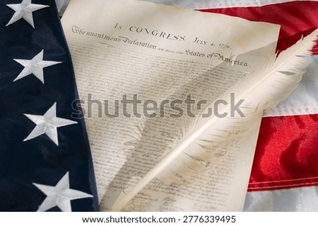 Document about the Declaration of Independence with an American flag and quill pen on July 4