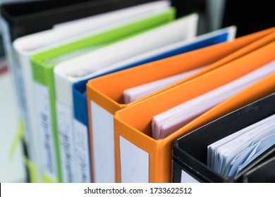 Document binder file folders stack on office desk in organization with report paper, paperwork record label, A lot of work information for businessman or lawyer organized archive database bookkeeping