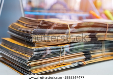 Document brochure informative paper documents also used for advertising that can be folded into template,Â pamphlet orÂ leaflet. Stacks of booklet business report papers on desk in modern office
