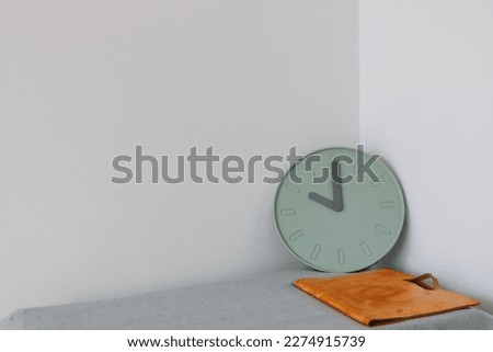 Document and clock on the table with empty space. Concept of work and time.