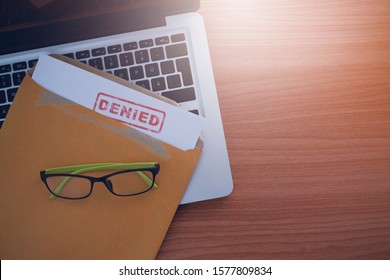 Document with denied stamp put on the laptop on wooden table, - Shutterstock ID 1577809834