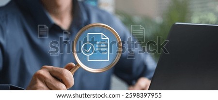 Document evaluation inspect. Contract agreement audit. Assessment survey evaluation check. A man is holding a magnifying glass over a laptop screen with a blue circle on it.