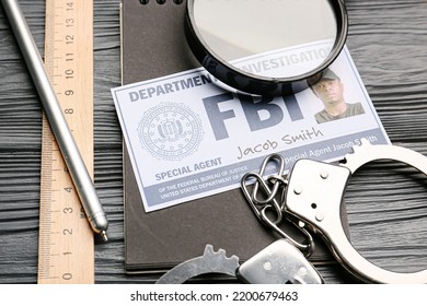 Document Of FBI Agent With Handcuffs, Magnifier And Stationery On Dark Wooden Background