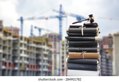 Document files with gavel on buildings under construction
