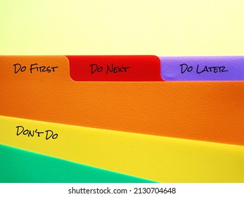 Document folder with tags labels DO FIRST DO NEXT DO LATER DON'T DO, concept of time management skills, knowing priority of tasks, difference between important and urgent tasks