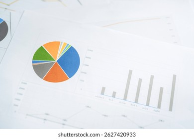 A document with a graph on it placed on a desk - Powered by Shutterstock - Get 15% off with code: PIKWIZARD15