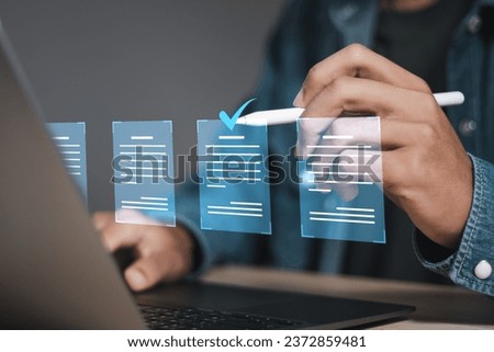 Document management concept, businessman using laptop with online quality assurance approval document. Verifying electronic documents on digital documents, paperless document management system.