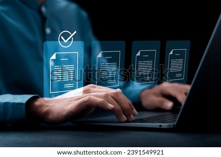 Document management concept, Businessman using laptop with online quality assurance approval document. Verifying electronic documents on digital documents, paperless document management system.