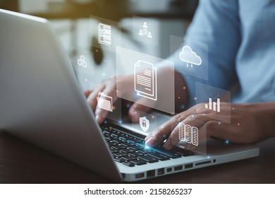 document management concept with icons on virtual screen, ERPBusinessman working on the computer for document management concept, online documentation database, and digital file storage system. - Shutterstock ID 2158265237