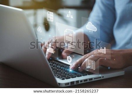document management concept with icons on virtual screen, ERPBusinessman working on the computer for document management concept, online documentation database, and digital file storage system. Photo stock © 