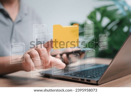 Document management control concept, A Man points at the folder icons and document management on a laptop DMS Online document database Secure document storage on the cloud computer system
