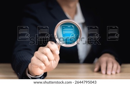 Document management, file search and auditing, folder data analysis. close up to hand, hold magnifier to search file to management. document is important too business.