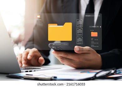 Document management system concept, business man holding folder and document icon software, searching and managing files online document database, for efficient archiving and company data. - Shutterstock ID 2161716033