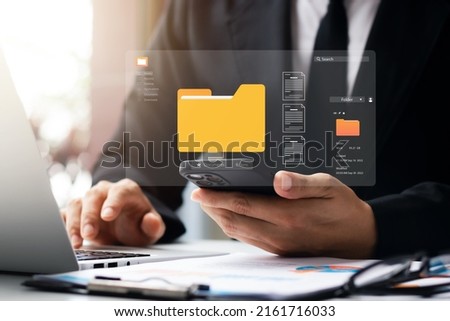 Document management system concept, business man holding folder and document icon software, searching and managing files online document database, for efficient archiving and company data. Foto stock © 