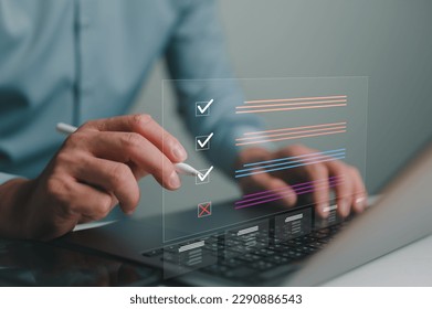 Document management system DMS. Assessment form, questionnaire, checklist and clipboard task management. Businessman working on laptop computer productivity checklist and filling survey form online.