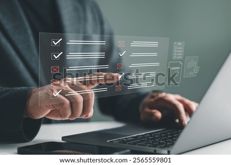 Document management system DMS. Assessment form, questionnaire, checklist and clipboard task management. Businessman working on laptop computer productivity checklist and filling survey form online.