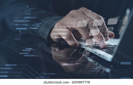 Document Management System (DMS) being setup by IT consultant working on laptop computer in office. Software for archiving, searching and managing corporate files and information - Shutterstock ID 2059897778