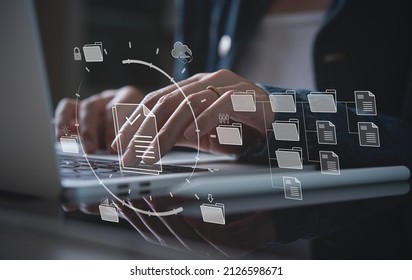 Document Management System (DMS) being setup by IT consultant working on laptop computer in office. Software for archiving, searching and managing corporate files and information - Shutterstock ID 2126598671