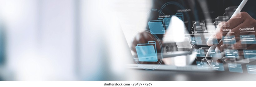 Document Management System (DMS) being setup by IT consultant working on laptop computer in office. Software for archiving, searching and managing corporate computer files, information, documentation - Powered by Shutterstock - Get 15% off with code: PIKWIZARD15