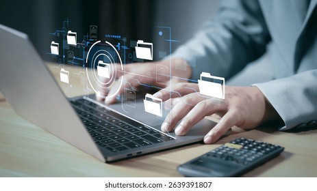 Document Management System (DMS) being setup by IT consultant working on laptop computer in office. Software for archiving, searching and managing corporate files and information