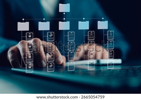 Document management system, DMS. Folder structure and classification system. File and folder icons. Businessman using laptop for controlling document versions.