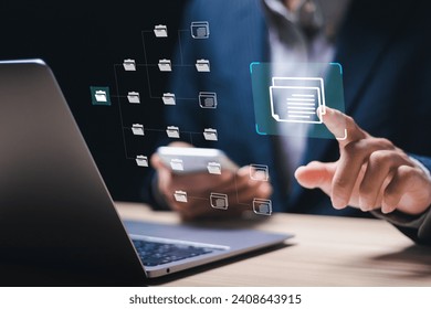 Document management system (DMS) technology, businessman use laptop with database folder online to store files document data digital. file storage process with security. 