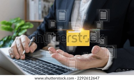 Document Management System (DMS),Businessman using a laptop searching folder and managing files paperwork.Software for archiving,share online document server, administration employee in enterprise.