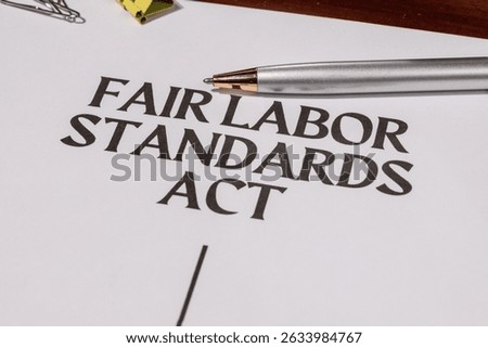 Document Marked ‘FLSA’ on Tabletop – Representation of Federal Labor Protections and Standards