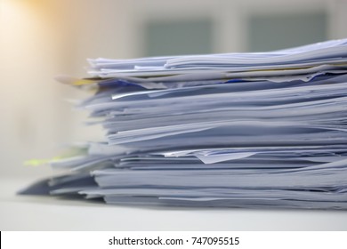 Document Pile On Office Desk, Stack Of Business Paper On The Table With Blurred Of Meeting Room Interior Background. Job Interview And Busy Business Concepts.