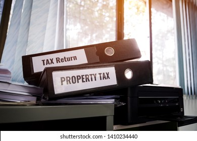 Document Reports Concept,Tax return and property tax folders stack with label on black binder on paperwork documents summary report in busy offices. HR-human resources business bookkeeping accountancy