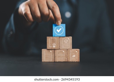 Document review process and quality control concept. Hand placing checkmark. Wooden blocks document icons, certified, document verification, business approval process, certificate management, audit,
